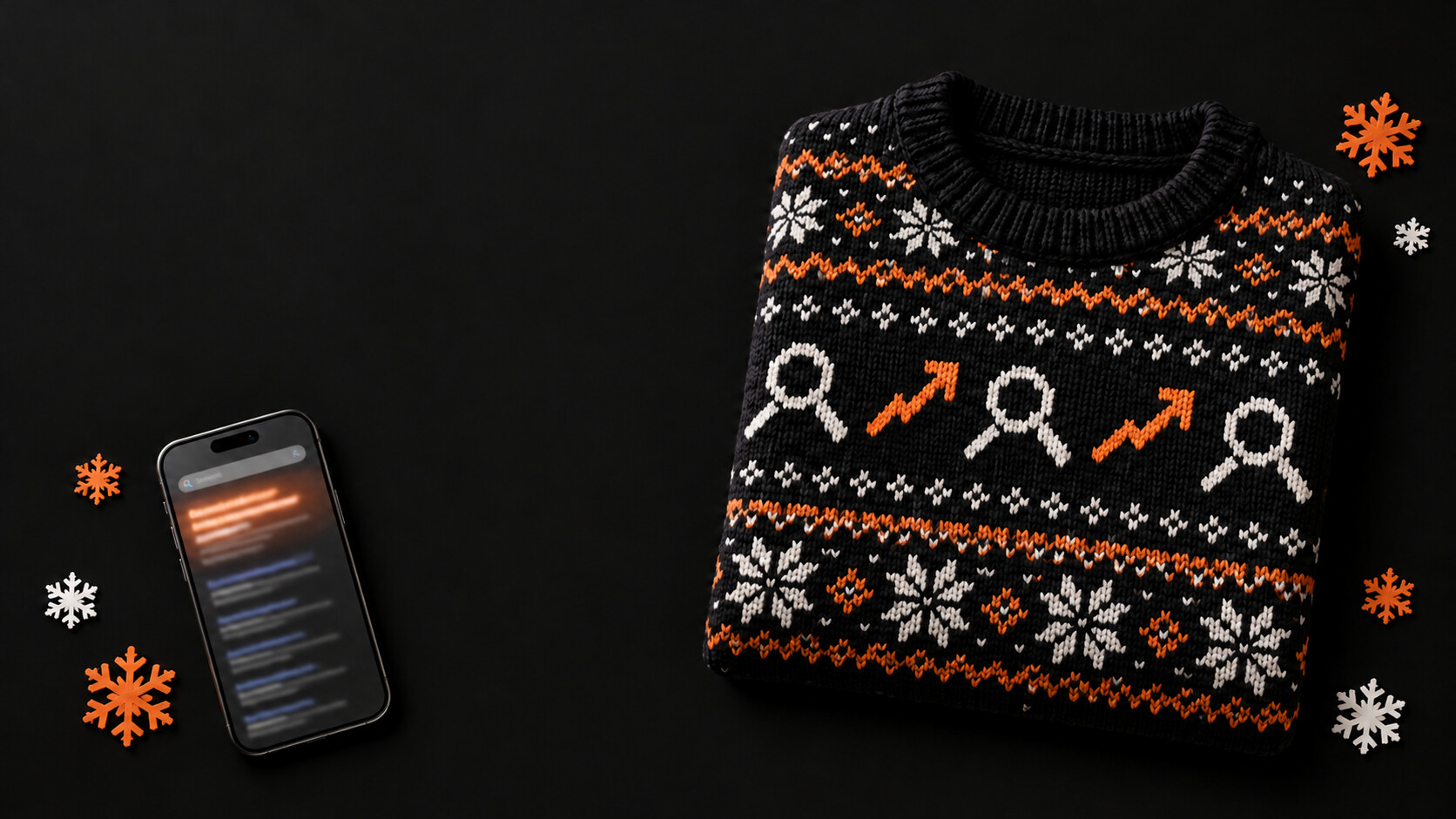 Black holiday sweater with orange and white knitted search icons and upward arrows beside a smartphone and paper snowflakes on a dark background.